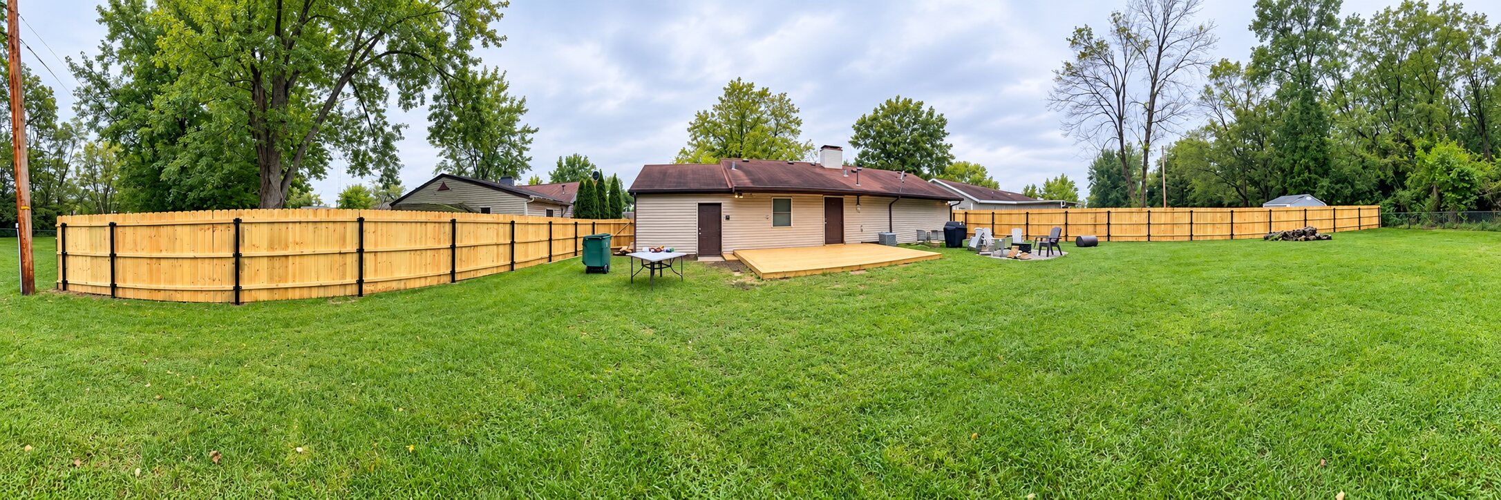 Backyard using partial wood privacy fencing with chain-link fencing around the remaining perimeter